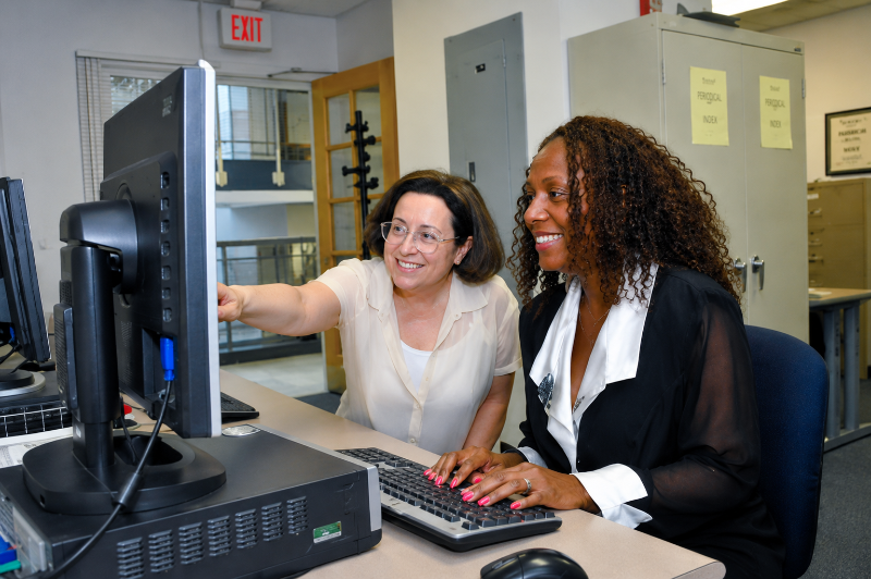 two woman tutors using computer