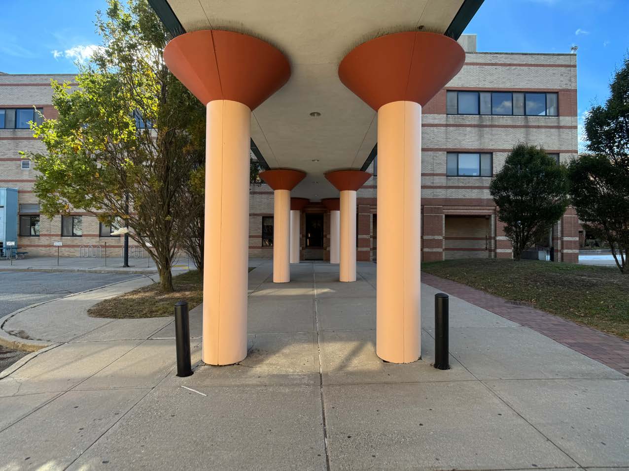 Photo of an area undreneath one of the building bridges outside.