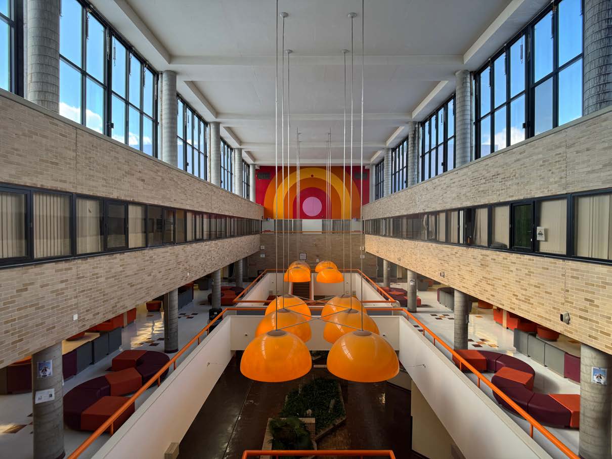 Photo of the orange lamps and the circle mural from the third floor of the Clusters.