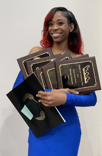 National track champion and women's basketball forward Mariana Richards has her hands full at the annual athletics banquet. Richards is one of the many student athletes helping to put Kingsborough's athletic program on the map.